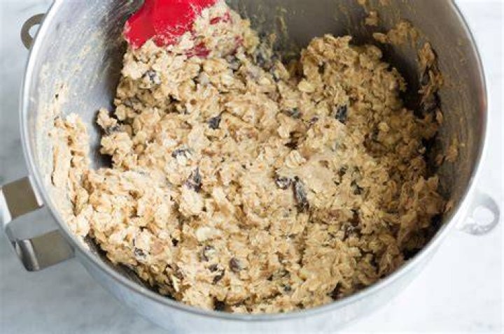 Collage of oatmeal cookie dough in a large glass bowl and oatmeal cookie dough balls on a baking sheet.