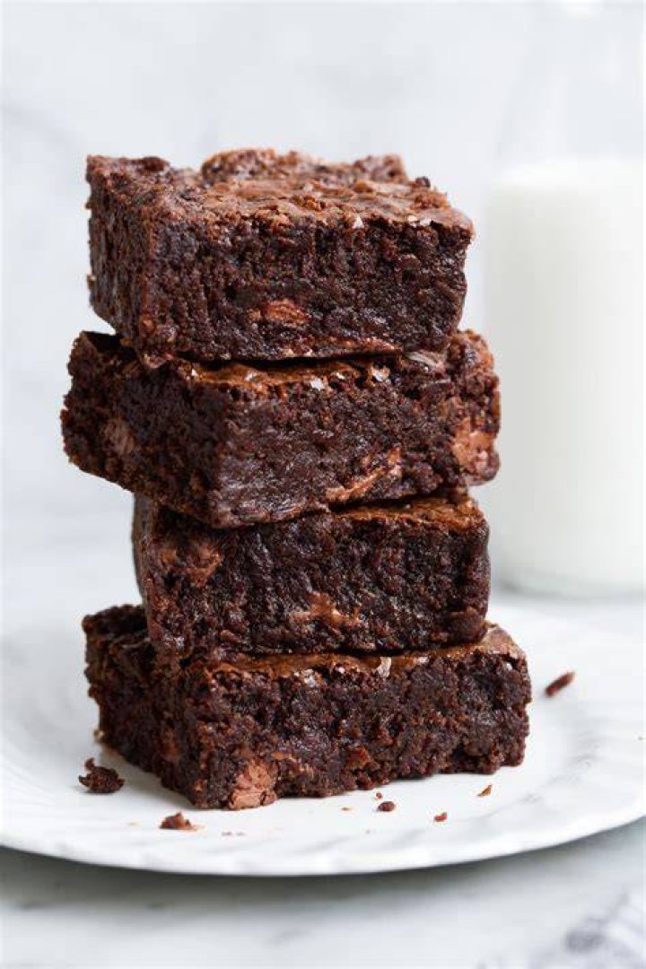 Stack of two homemade brownies on a wire rack.